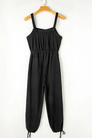 Black textured jumpsuit, back view on wooden hanger