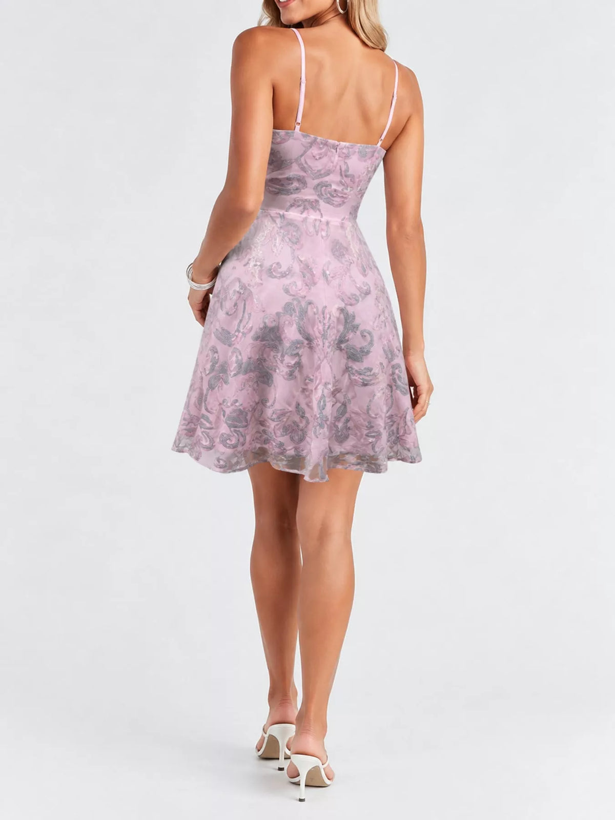 Back view of the pale lilac mini dress showing adjustable straps and silver-toned sequins.