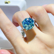 Blue-green moissanite ring worn on hand