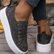 Charcoal platform sneakers showing the laces from above and the rear heel tab