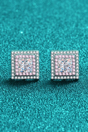 Pair of square pink-and-clear stone studs on a teal textured surface