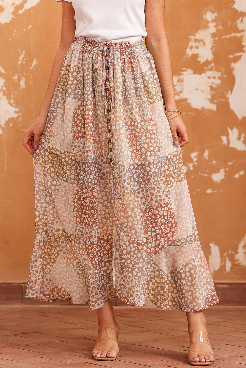 Front view of peach and cream floral button-front midi skirt