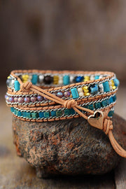 Back view of the multistrand stone bracelet and its adjustable cord closure.