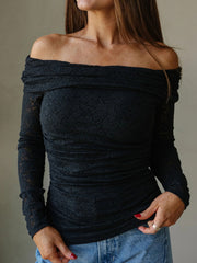 Front view of fitted black off-shoulder top