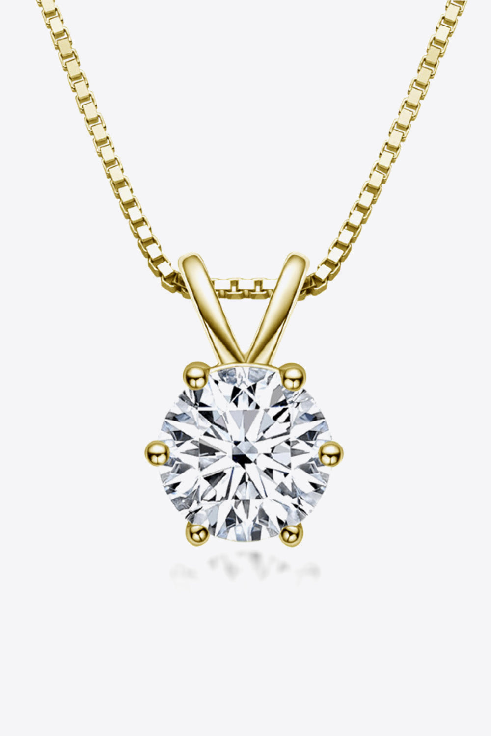 Round clear-stone solitaire pendant on a gold-tone chain against white