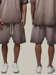 Models wearing taupe drawstring shorts, front and back views