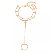 Gold-tone chain bracelet with rhinestone cross charm shown flat