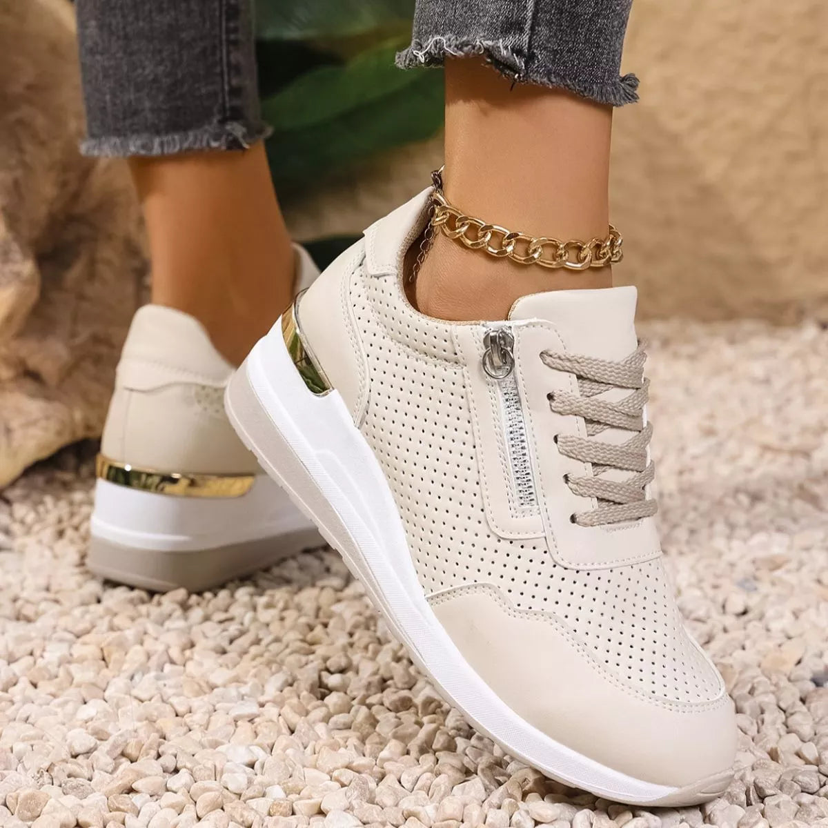 Close view of cream knit sneaker showing laces and textured upper