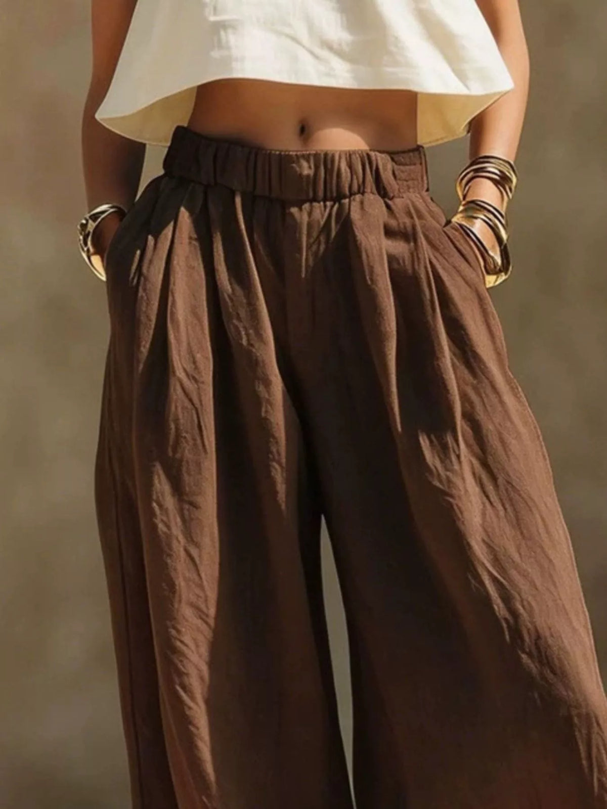 Brown wide-leg pants shown full length with relaxed drape