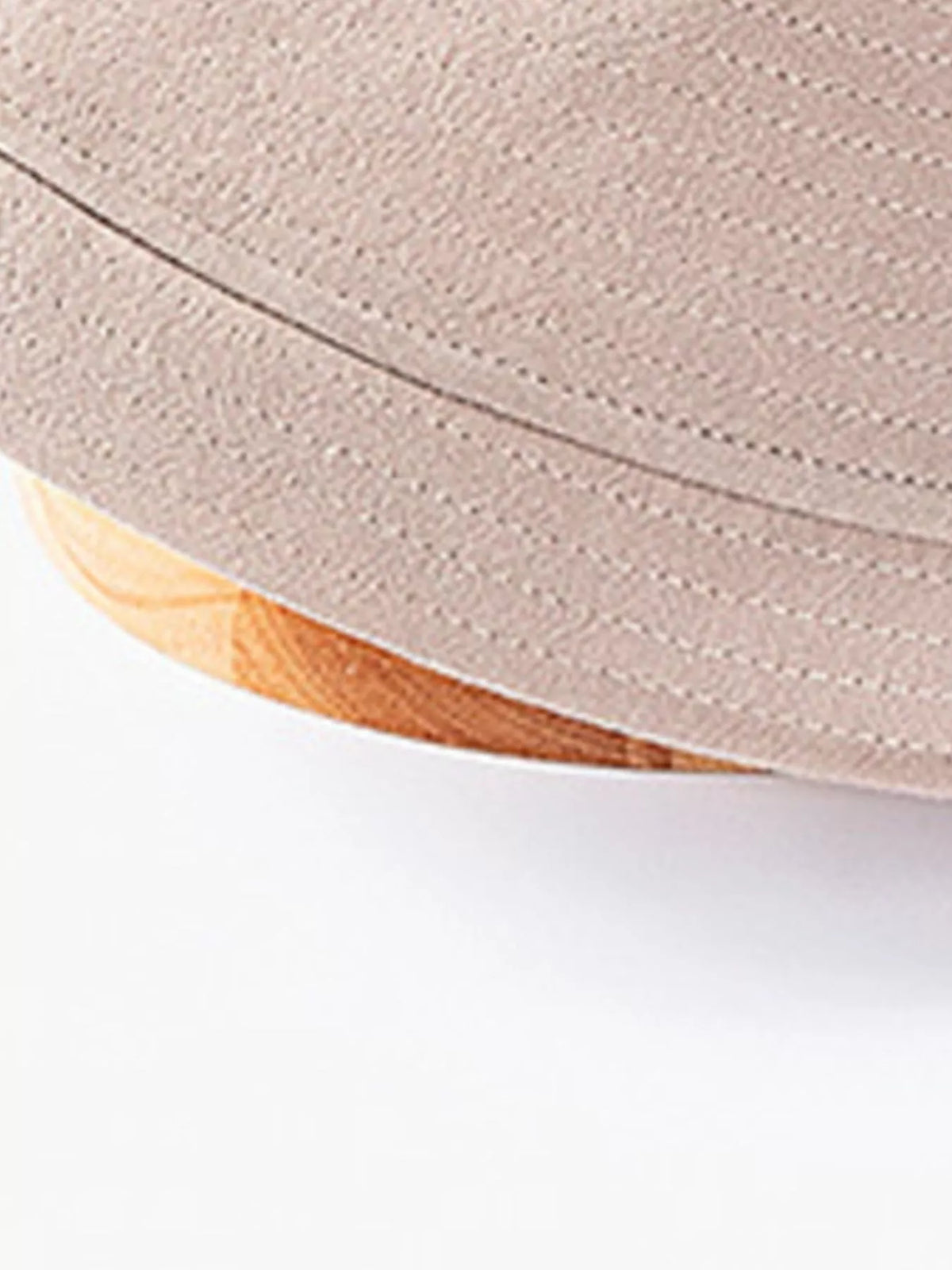 Close-up of khaki hat brim with rows of stitching