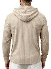 Back view of beige textured hoodie showing hood and ribbed pattern