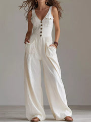 Model wearing white sleeveless button-front wide-leg jumpsuit, front view