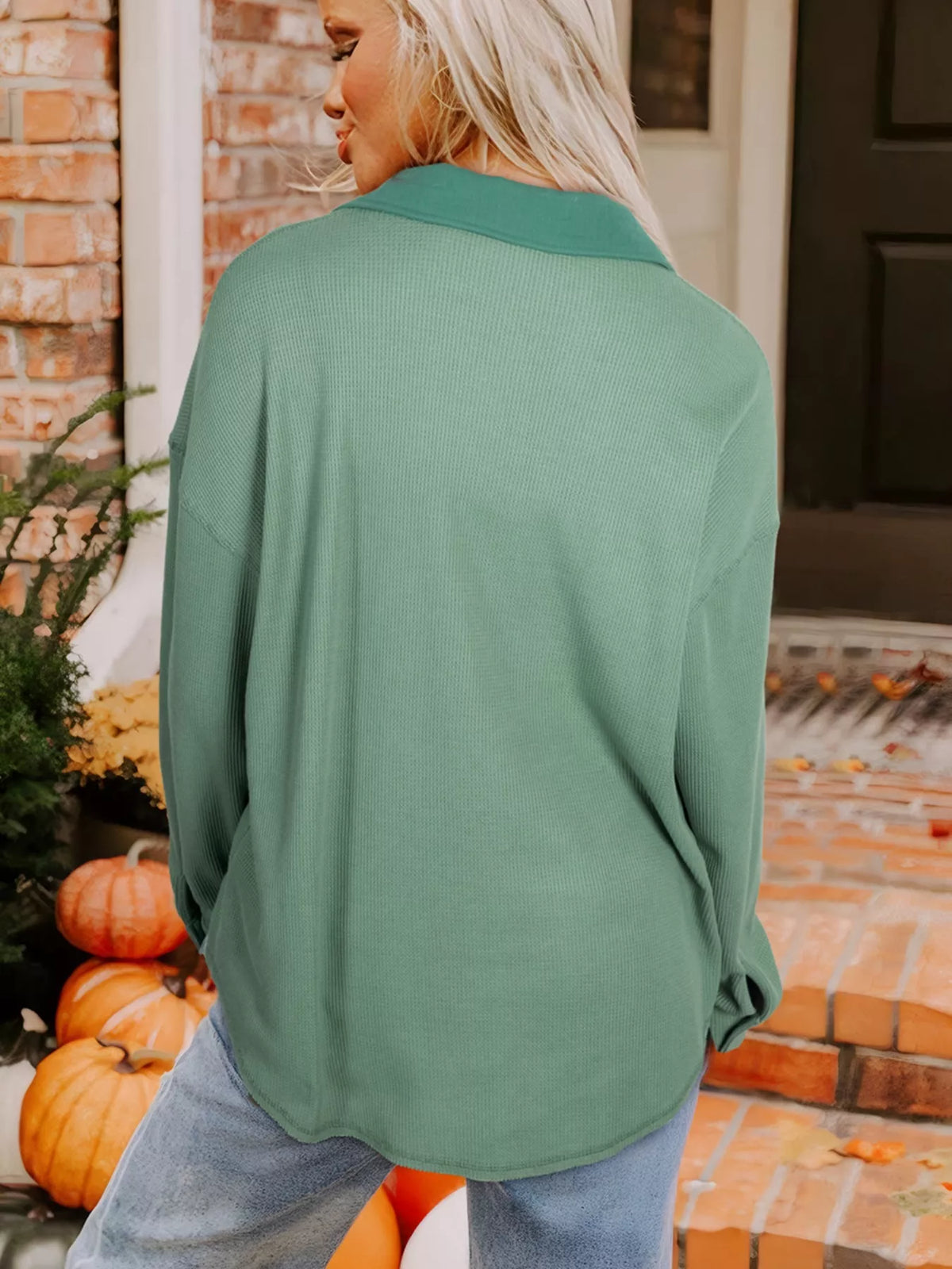 Back view of sage button-up shirt on model