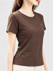 Brown short-sleeve T-shirt with small crown emblem, shown on a model from the front at an angle.