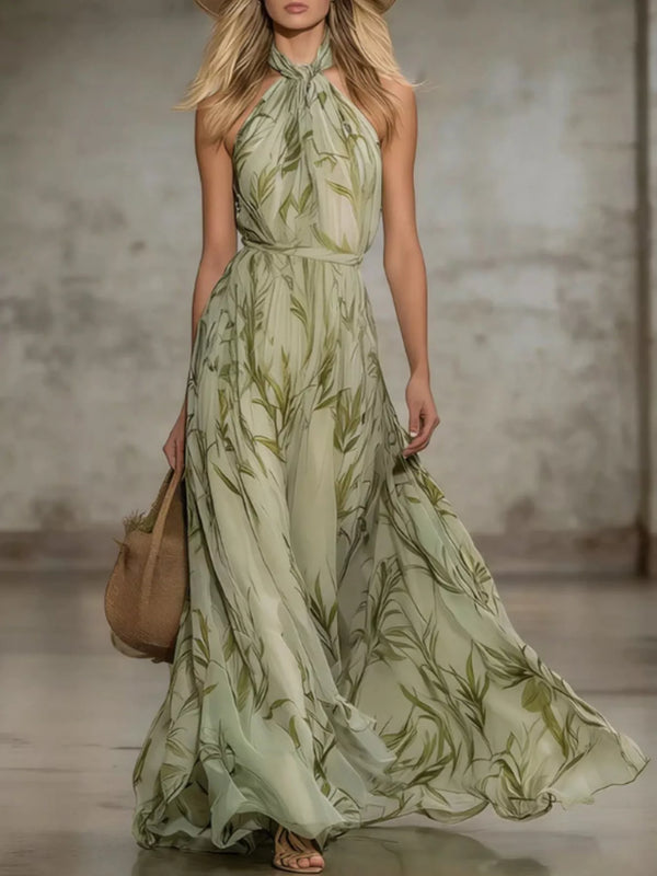 Front view of a sleeveless pale green chiffon maxi dress with an allover leaf print.