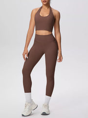 Front view of brown halter-neck crop top and high-waisted leggings