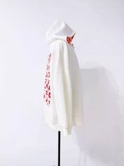 Side view of white zip hoodie on display with the back print partly visible