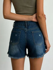 Back view of dark-wash denim shorts with distressed details