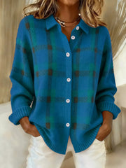 Blue and teal plaid button-up cardigan on a model with hands in trouser pockets.