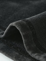 Close-up of the soft-looking black fabric draped at the hem