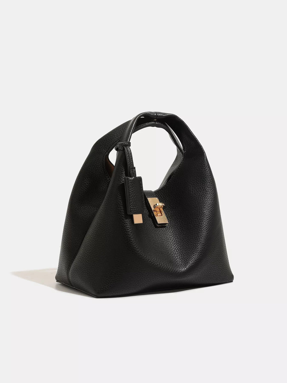 Black pebbled turn-lock handbag viewed from the side