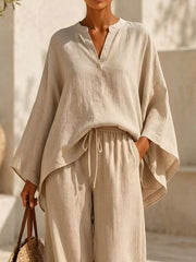 Closer view of beige set showing the notched neckline, loose sleeves and tied waist.