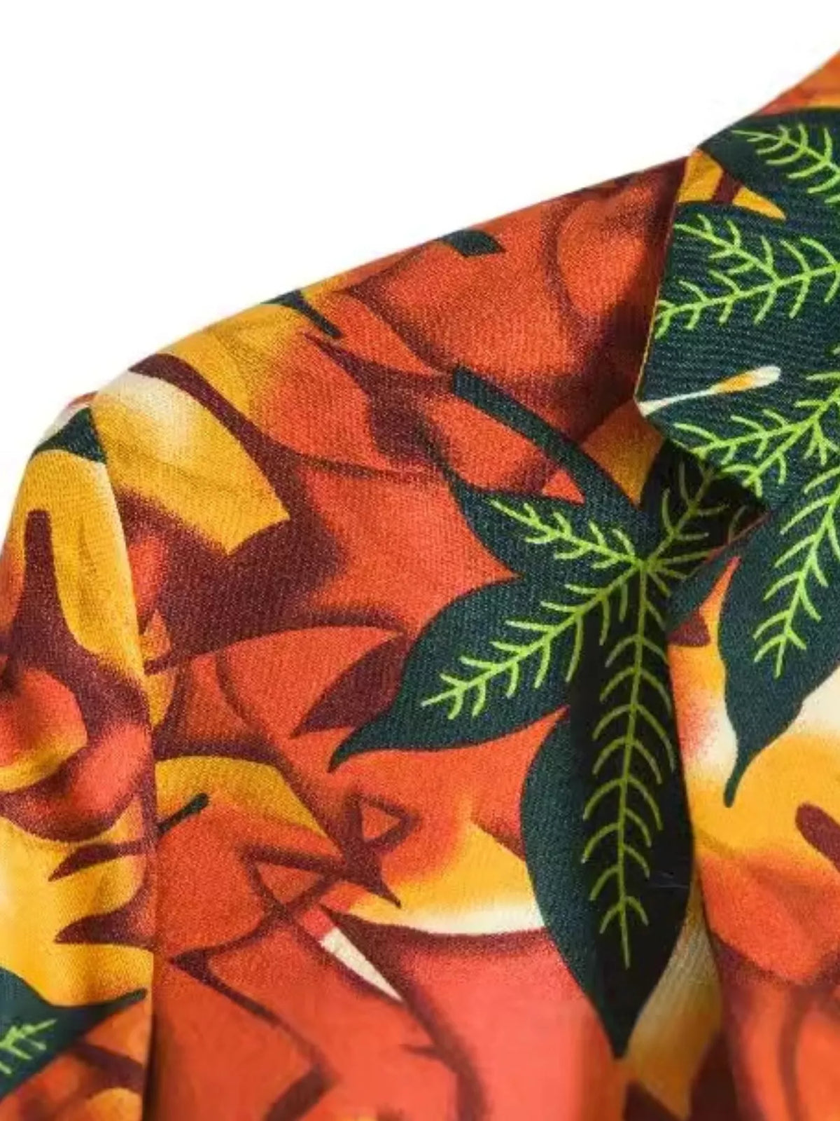Close-up view of the blazer's leafy print fabric in contrasting colors
