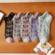Five textured floral ankle sock pairs in black, grey, burgundy, lavender and pale green