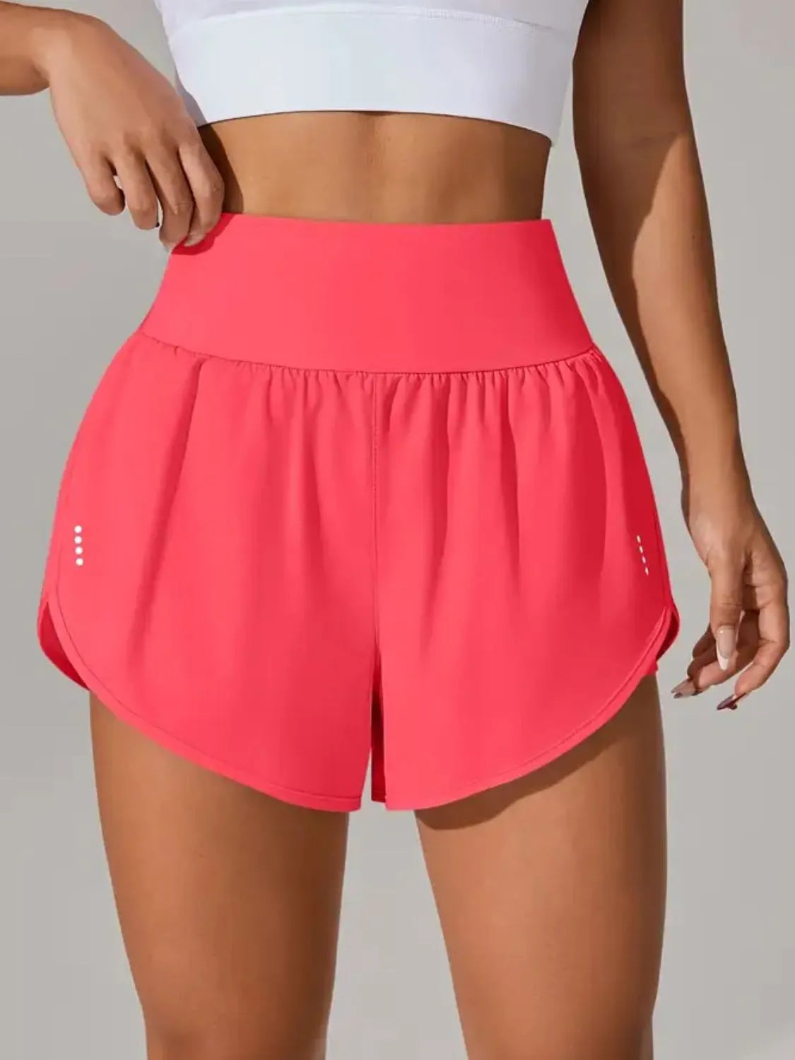 Hot pink high-waisted running shorts shown from the front