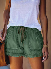 Green drawstring denim shorts with front patch pockets and frayed hems