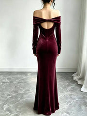 Burgundy velvet maxi dress showing the open back and crossed off-shoulder straps
