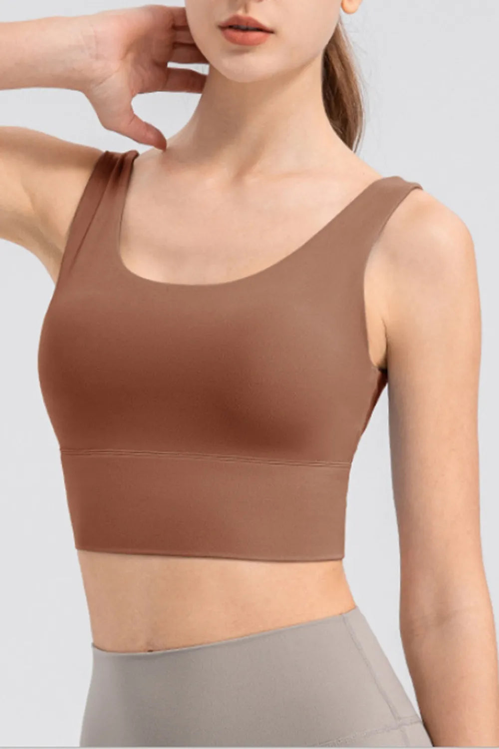 Brown cropped tank shown from the front with wide shoulder straps