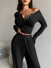 Close view of black top's off-shoulder neckline and buttons