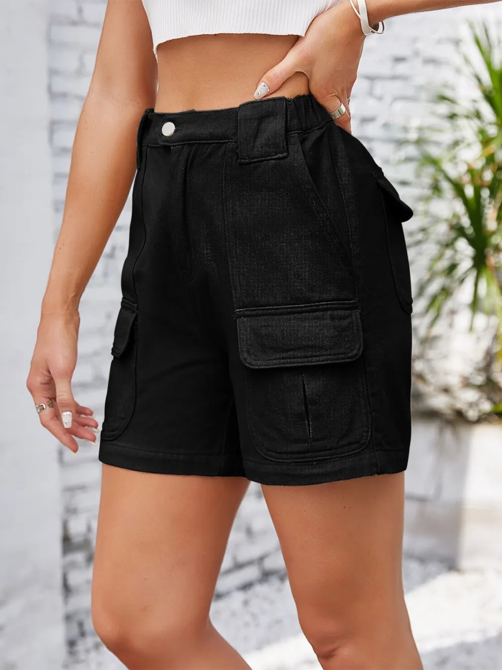 Front view of black shorts with cargo pockets and rolled hems.