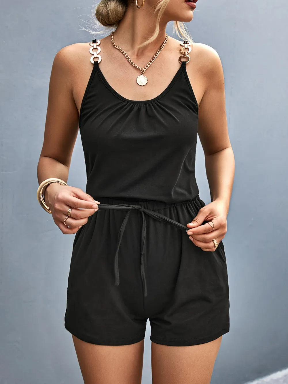 Black scoop-neck romper with decorative shoulder rings