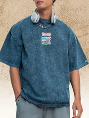 Model wearing a blue vintage-wash T-shirt with a small cassette graphic