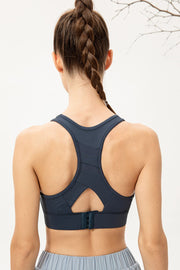 Back view of navy racerback sports bra with keyhole opening and hook closure