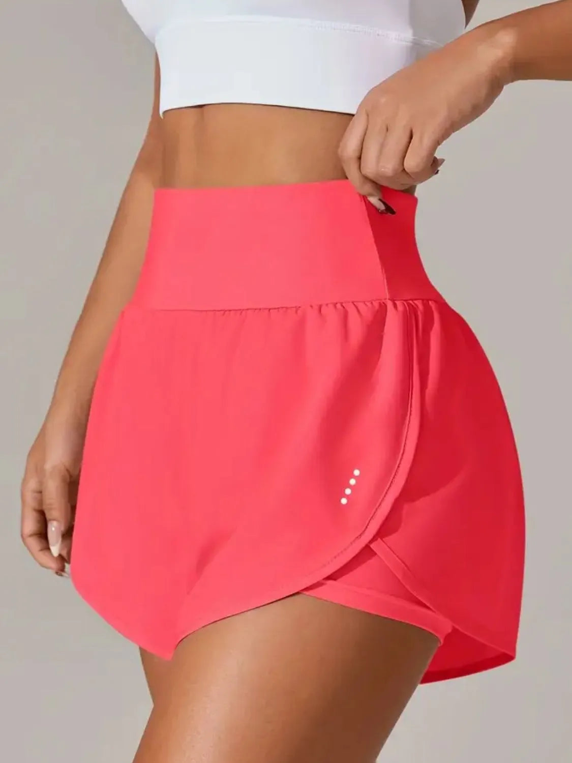 Bright pink wrap-overlay active shorts, close side view