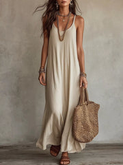 Model wearing a simple beige spaghetti-strap maxi dress, front view