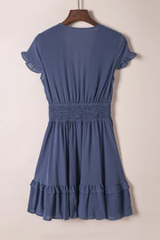 Back view highlighting smocked waist and ruffle skirt
