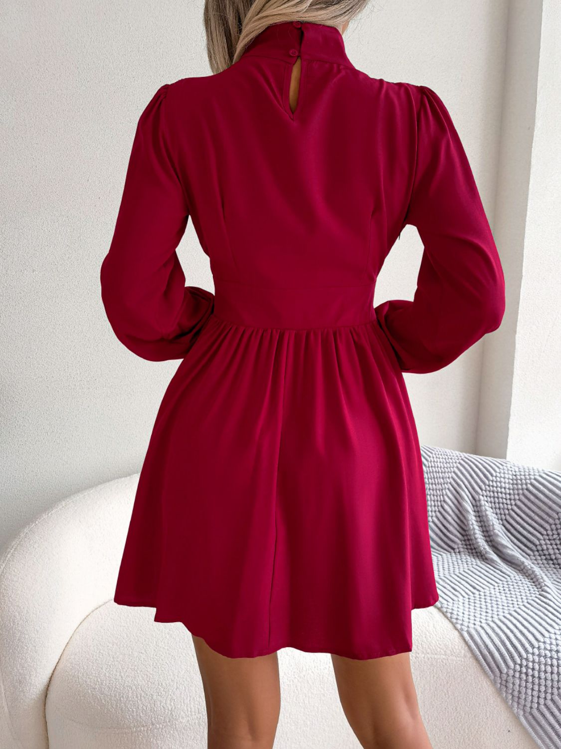 Back view of burgundy cutout turtleneck mini dress