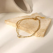 Two gold bracelet chains shown arranged together