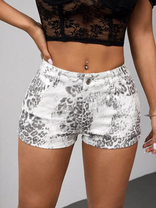 Front view of grey leopard-print denim shorts worn with a black lace crop top