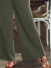 Close view of olive side stripe and hem