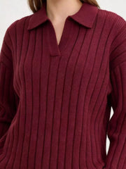 Close view of burgundy sweater's collar and ribbed knit pattern