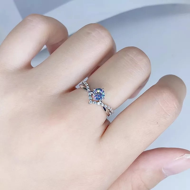 Blue rectangular center-stone ring with a pavé-set silver band, shown on a hand.