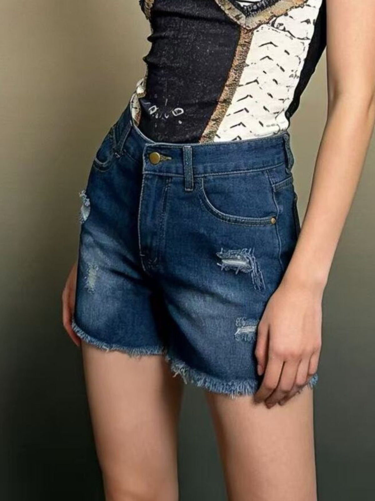 Front view of distressed denim shorts in a medium wash