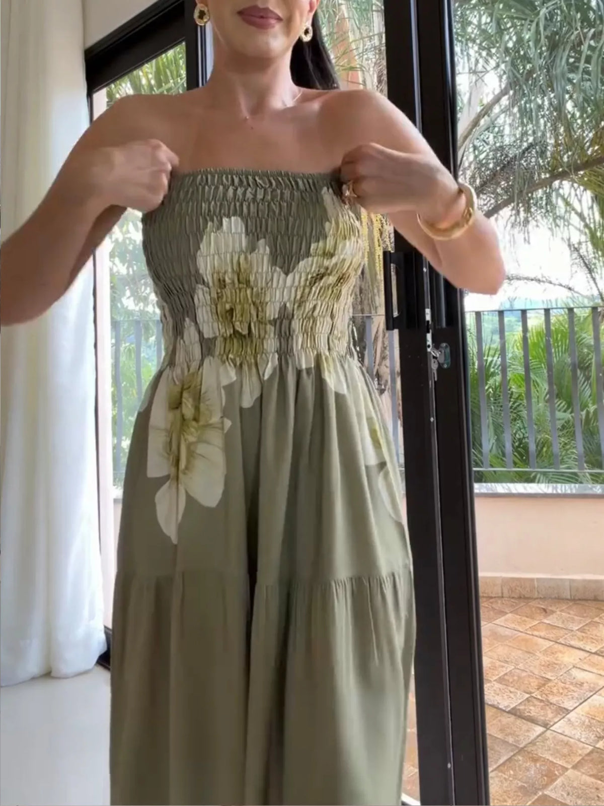 Close view of the smocked bodice and floral pattern on the strapless dress.