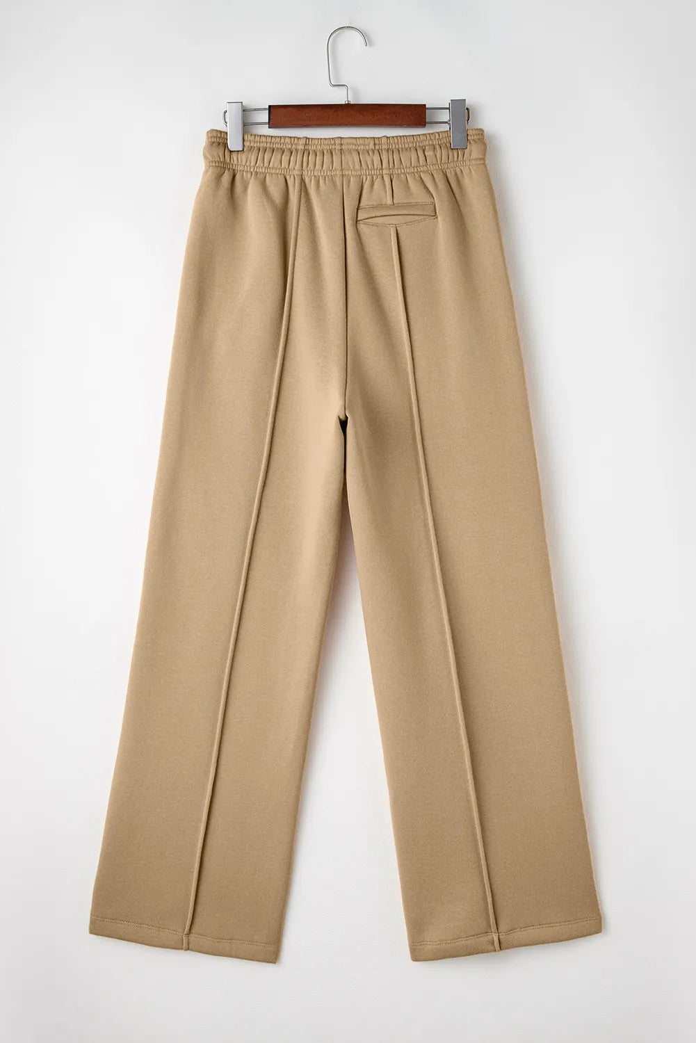 Back product view of tan wide-leg trousers with elastic waistband.