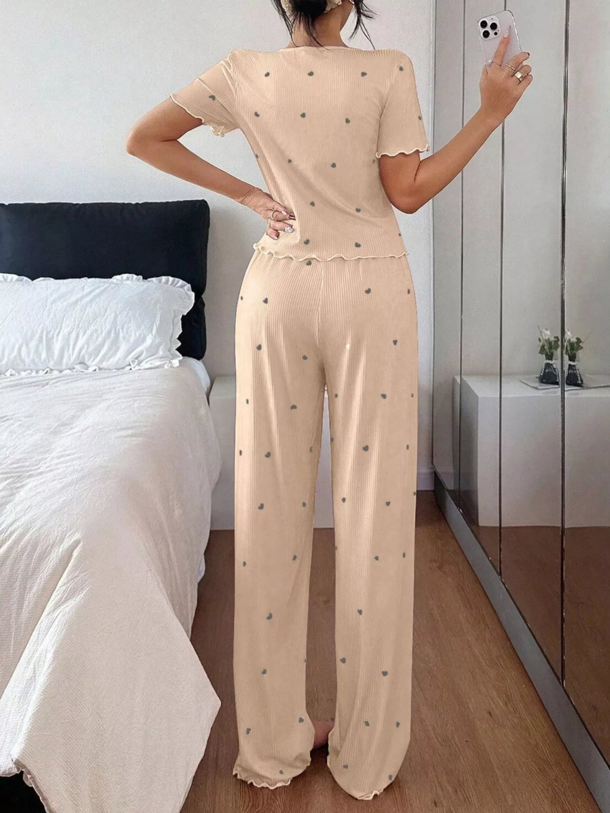 Back view of beige heart-print top and pants